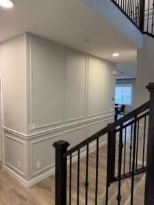 Custom slat wall and hidden door installation in Calgary condo by Calgary Custom Concepts