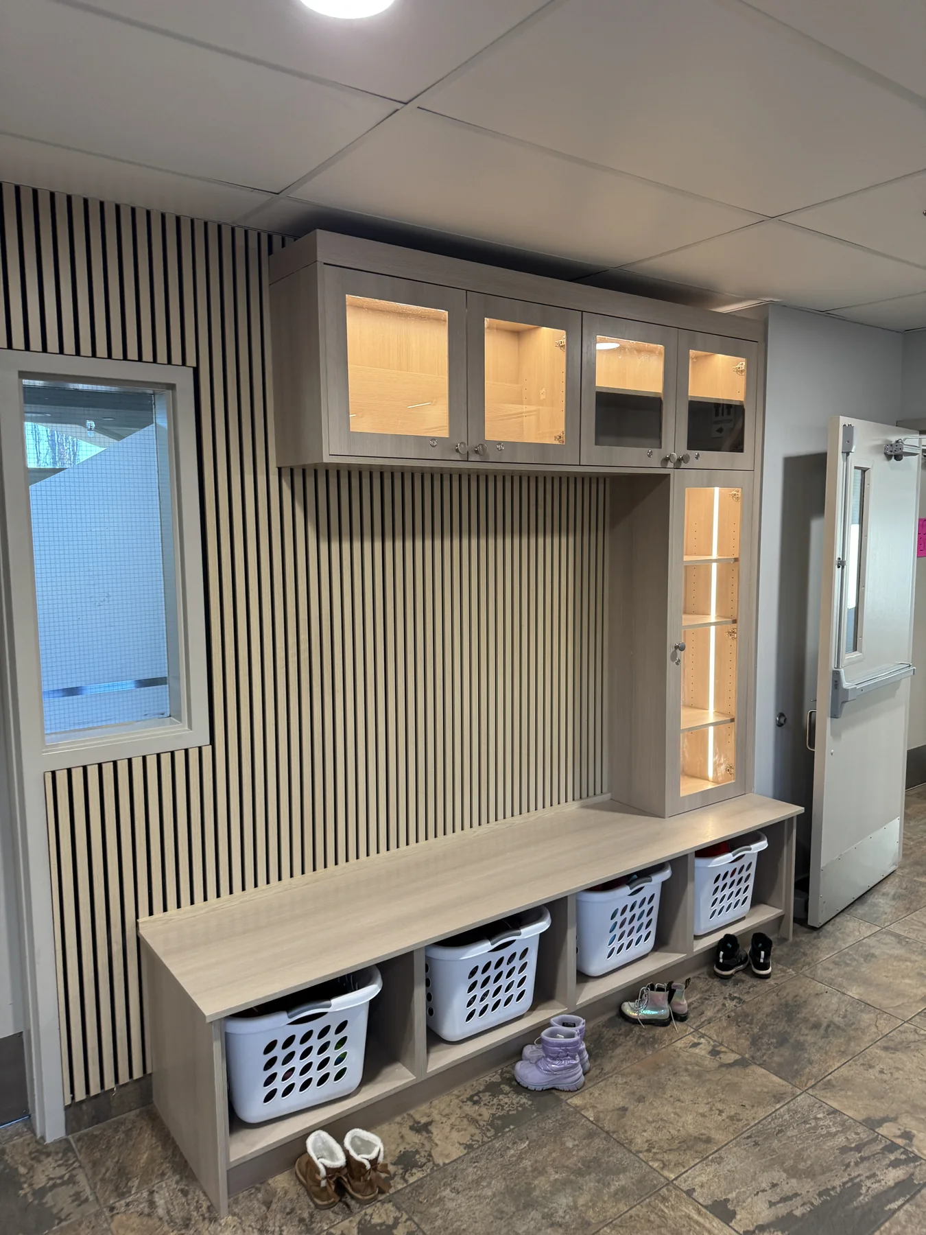Completed illuminated cabinetry and storage cubby in Tuscany