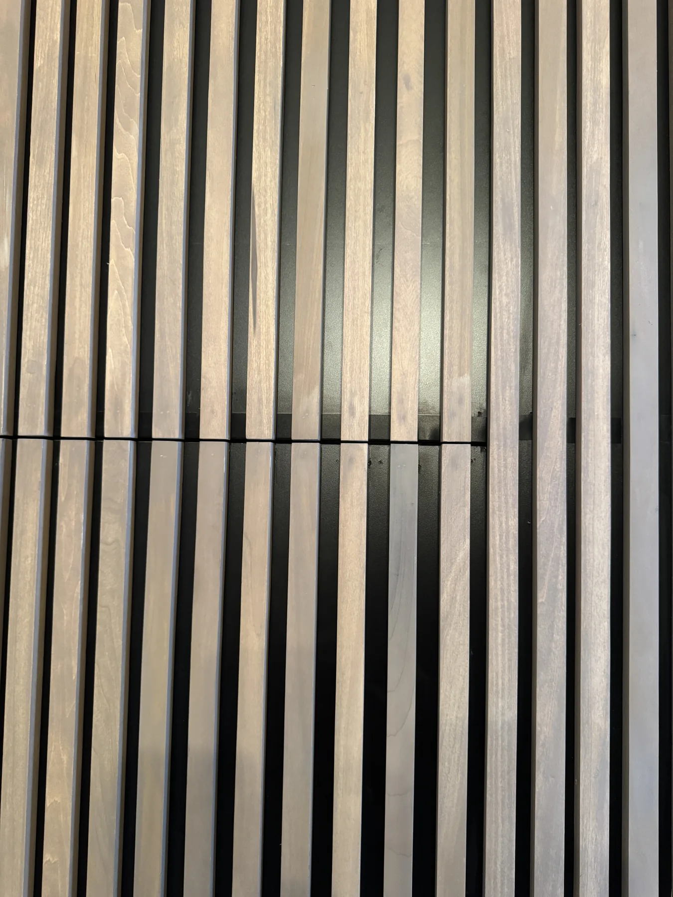 Close-up of the aligned aspen slats across a door opening