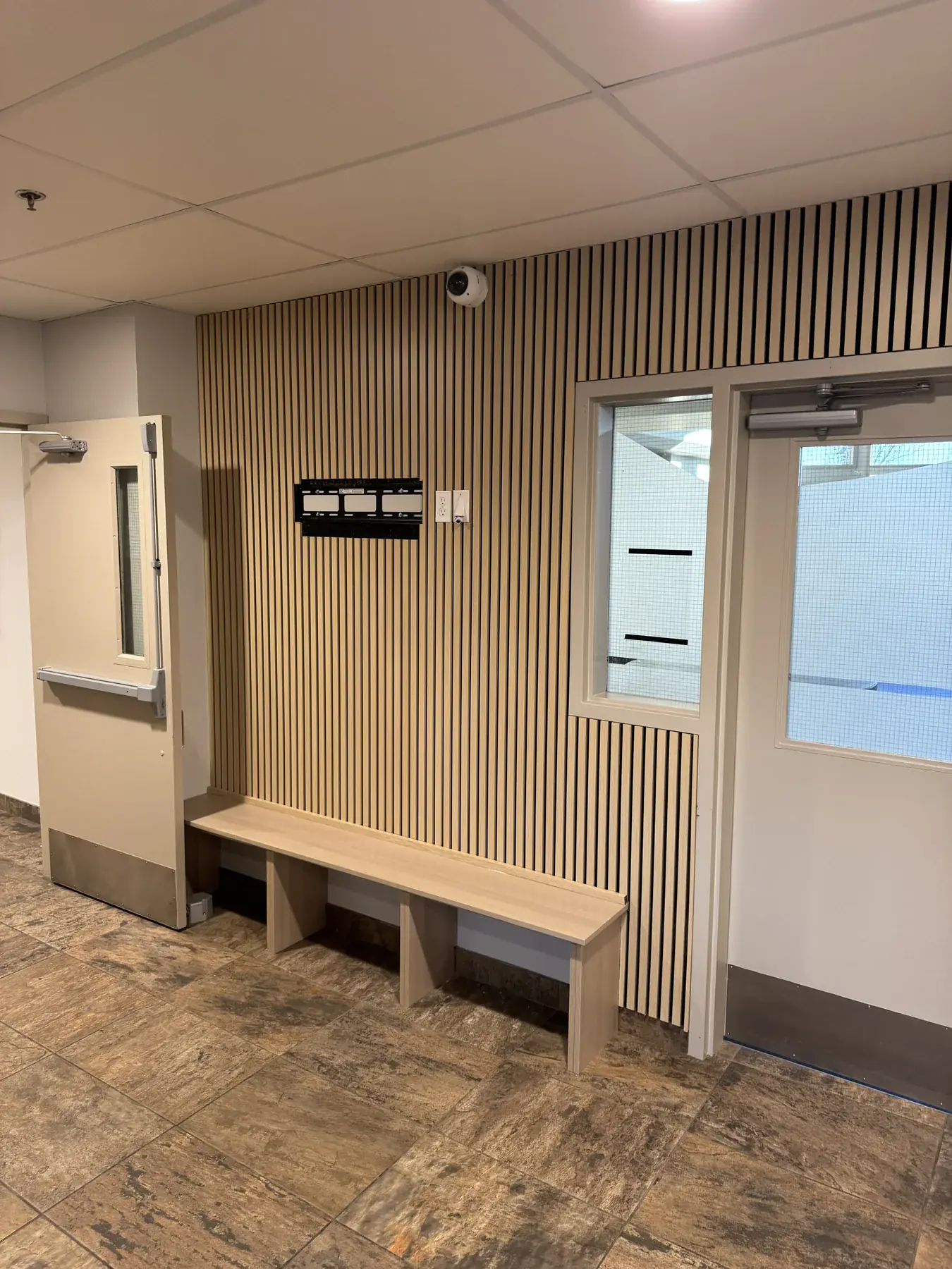 White oak acoustic slat wall with a fitted bench