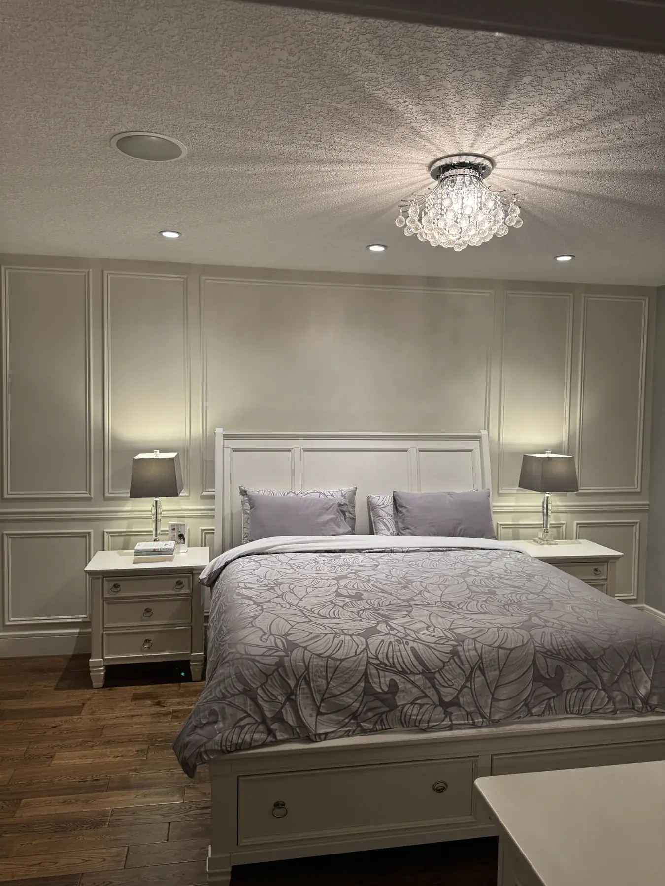 Full-height paneled feature wall in the primary bedroom