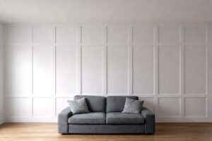 White grid-panel feature wall completed behind a sofa in a Calgary home.