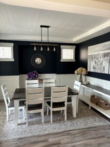 Completed navy Calgary dining room with white wainscoting and built-in bench.